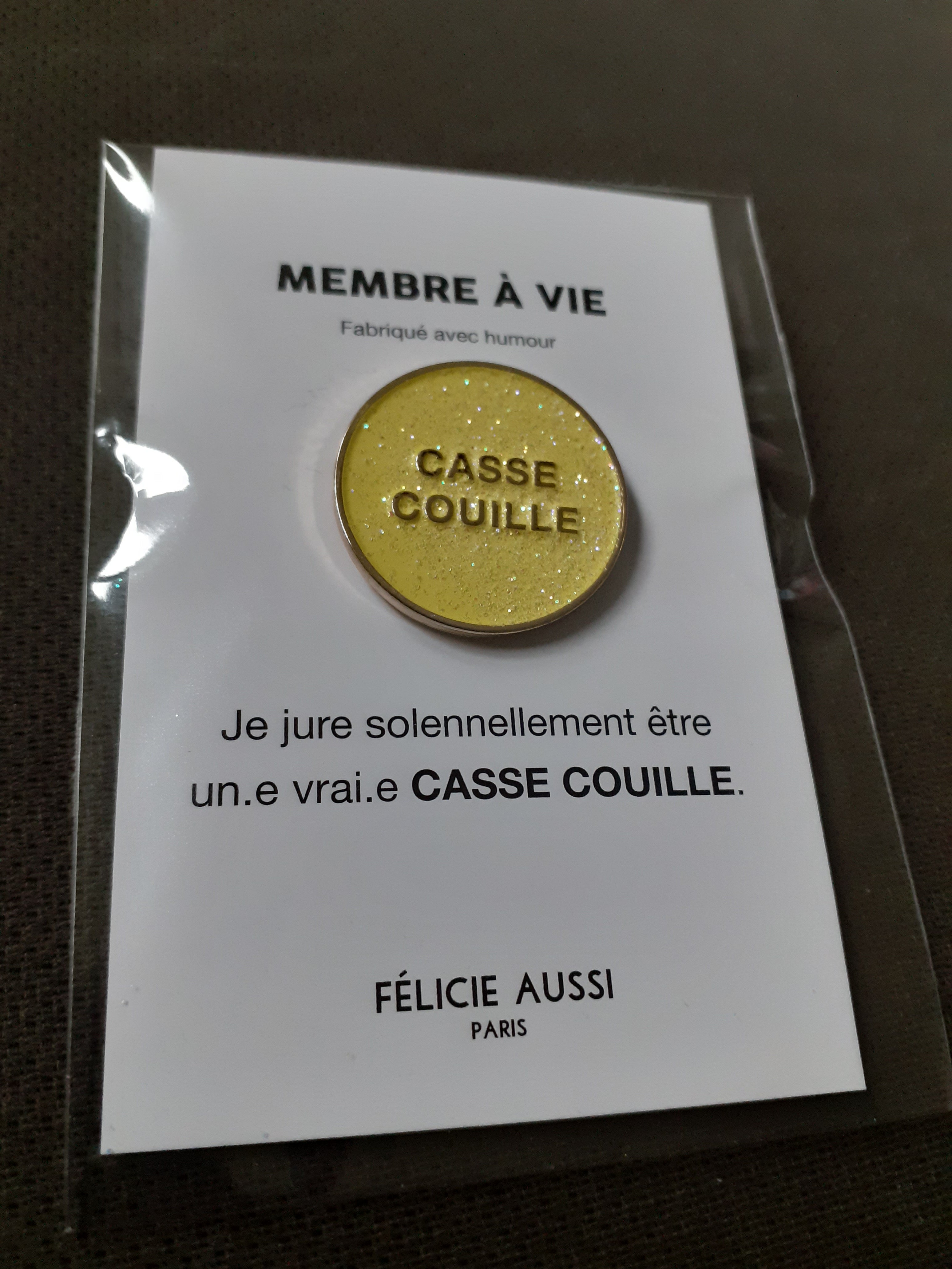 Pin’s à paillettes - CASSE-COUILLE - rond jaune